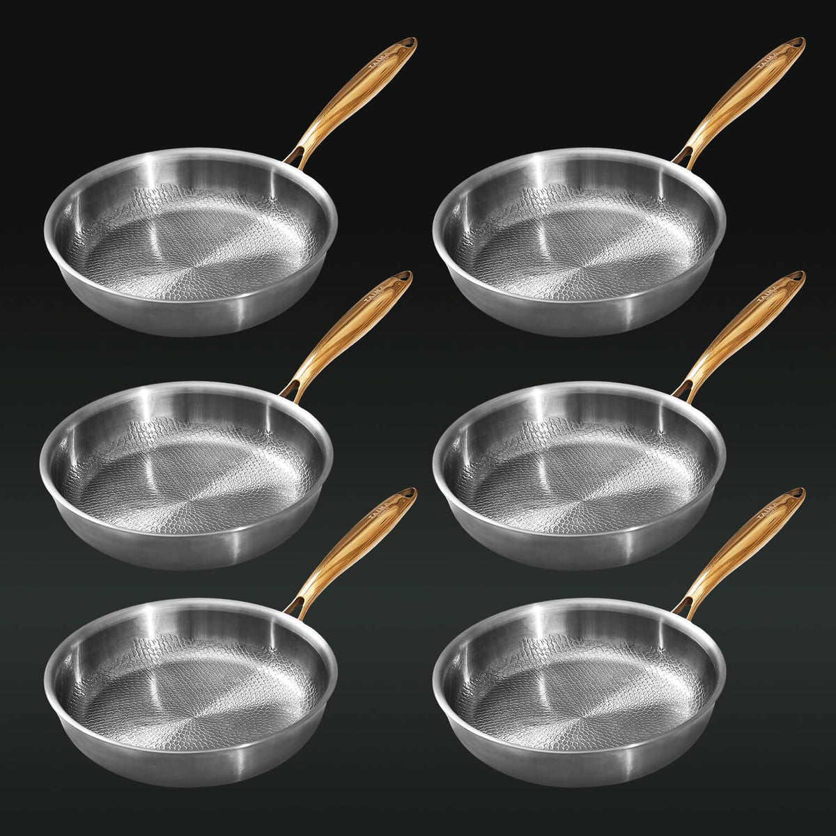 Set of six silver frying pans with gold handles on a black background